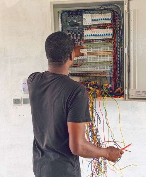 Electrician balancing phase loads at a distribution board